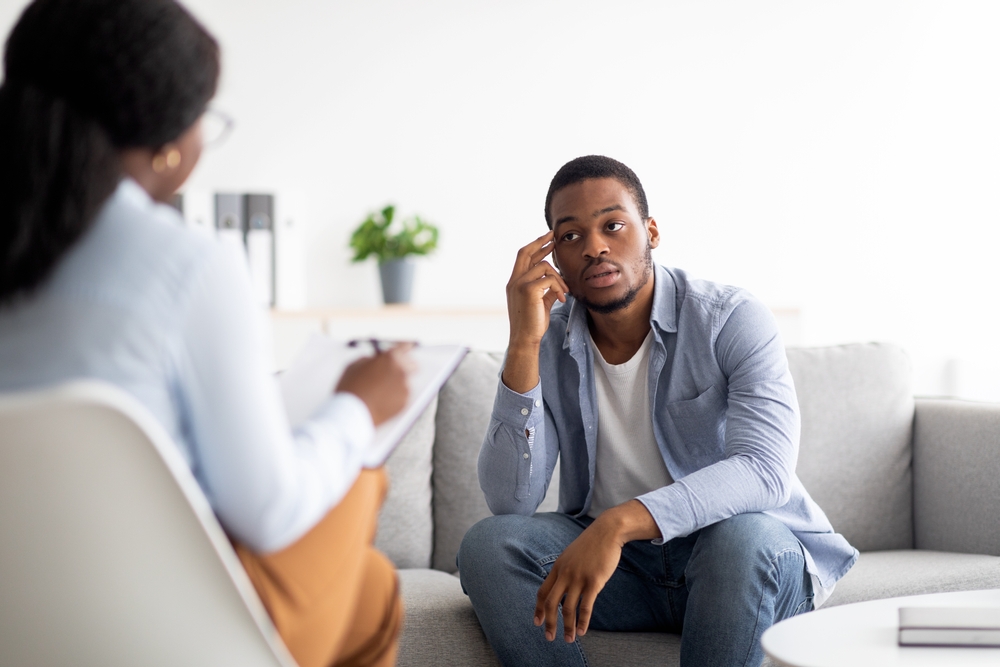 Stressed,Black,Man,Suffering,From,Depression,,Counselor,Providing,Professional,Assistance addiction and trauma treatment